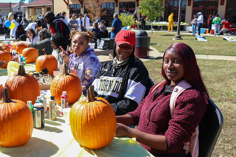 Group of females painting pumpkins